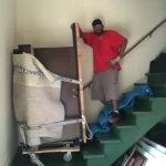 Man Posing With Large Object on Stairs