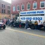 People Standing in front of Piano Movers Plus Truck